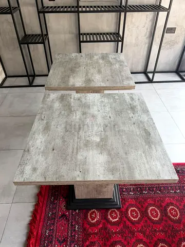 Solid square dining table with concrete-look top — good condition