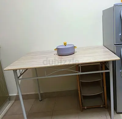 Simple rectangular dining table with light wood top and metal legs