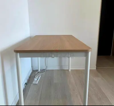 Simple IKEA-style wooden study table with white metal legs