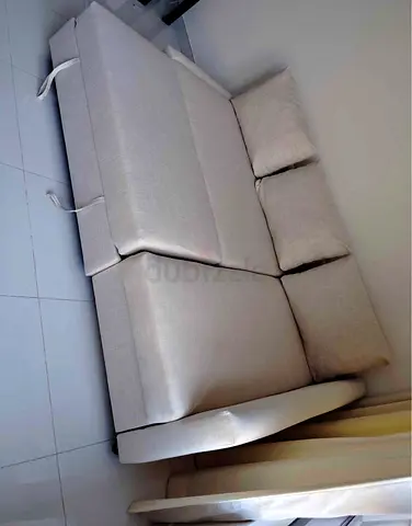 Light beige sofa bed with cushions - good condition