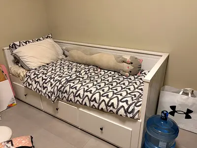 White IKEA wooden daybed with 3 under-bed drawers