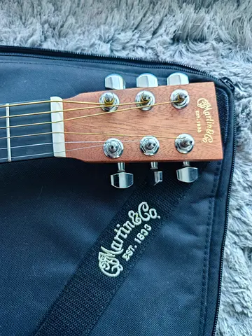 Martin acoustic guitar (headstock shown) in soft case - brand new
