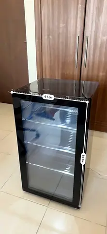 The refrigerator has been used only once; it is new, beautiful, and has a glass