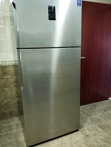 Silver top-freezer refrigerator - good condition. Price negotiable