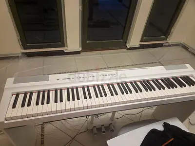 White digital piano with stand and pedals — gently used