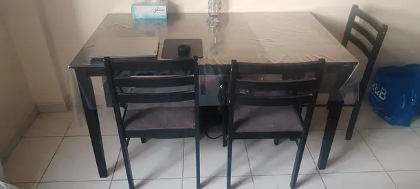 Simple black dining table with 2 chairs - good condition, kitchen shelf free with table.
