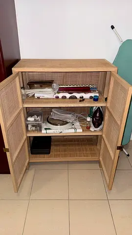 Woven rattan cabinet with two doors.