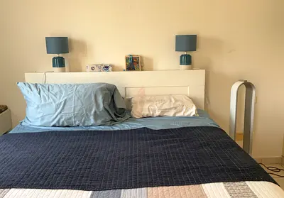 Queen bed frame with drawer storage and headboard with shelving.