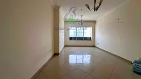 spacious 3-bedroom apartment with a living room in Sharjah, featuring built-in wardrobes, a gym, and