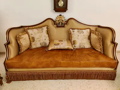 Vintage Gold-Trimmed Three-Seater Sofa with Tassel Skirt and two matching single seats.