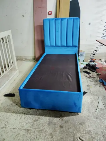 Single blue upholstered bed with headboard - good condition