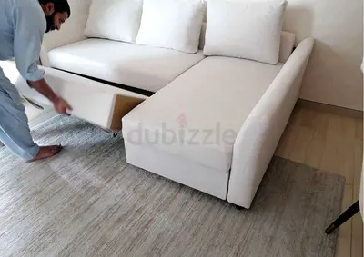Light beige L-shaped sofa bed with storage and removable cushions - good condition