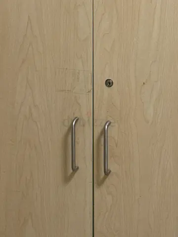 Light wood two-drawer cabinet with metal handles
