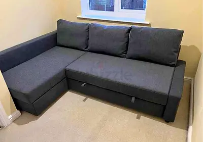 L-shaped dark grey fabric sofa bed with storage, good condition