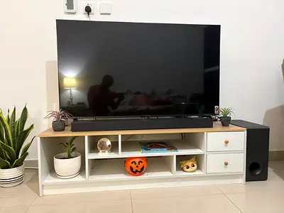 Low white TV unit with storage shelves and drawers - good condition