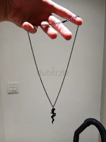 Black metal chain necklace with small snake pendant