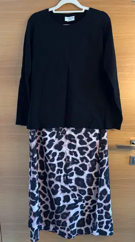 Black long-sleeve top with leopard print skirt