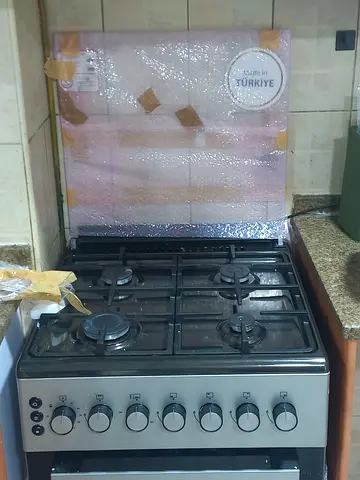 Used stainless steel 4-burner gas stove with oven - good condition