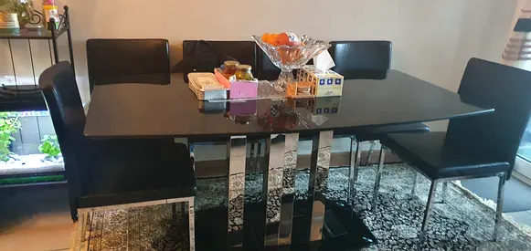 Black six seater dining table with six chairs