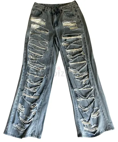 High-waisted blue heavily ripped straight-leg jeans, size approx M