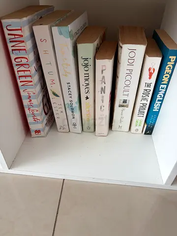 Used collection of popular fiction paperbacks by authors like Jojo Moyes, Jodi Picoult, Jane Green