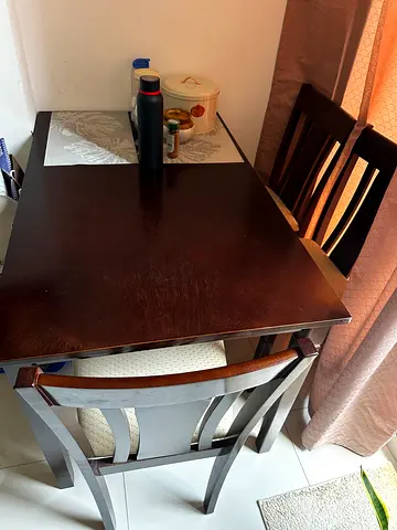Dark wood 4-seater dining table with chairs — good condition