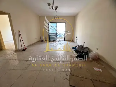 Spacious two-bedroom apartment with a living room available for rent in Al Qasimiya, featuring a sophisticated architectural design. Amenities include