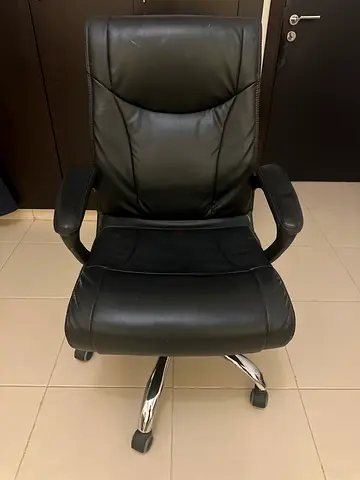 Black leather executive office chair with wheels