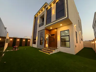Luxury family villa for sale in Al Helio, Ajman, featuring a modern design, four master bedrooms, a majlis, and two living areas. The price includes r