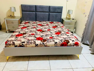 Queen bed frame with upholstered headboard and bedside tables