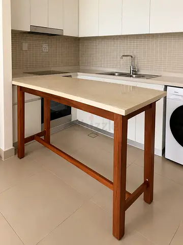Elegant marble-top bar counter with solid wood legs. Good condition. AED 450.