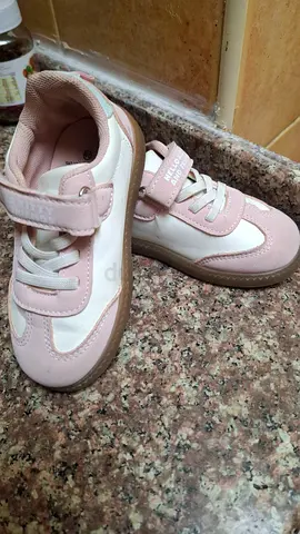 Light pink and white kids sneakers, size likely toddler/children