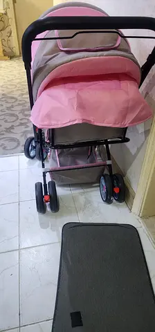 Lightweight pink baby stroller/pram in good condition