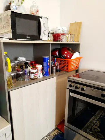Compact kitchen cabinet/storage unit with microwave shelf