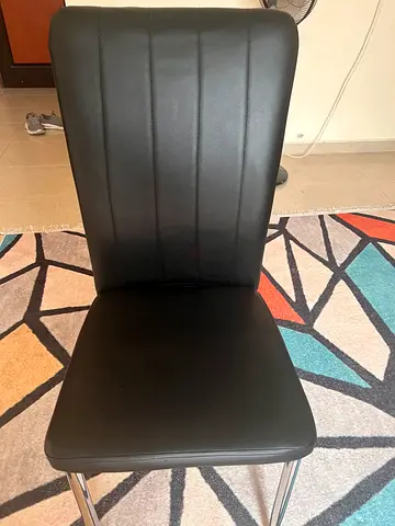 Black faux leather dining chair with chrome legs - single