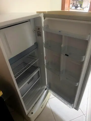 Small white single-door fridge in good working condition