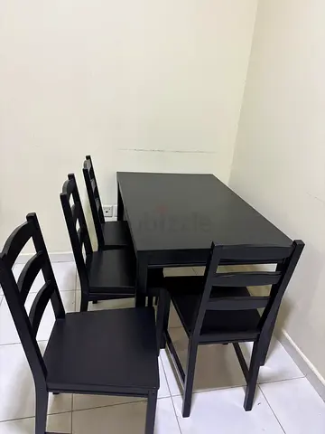 Black wooden dining table with 4 matching chairs - good condition