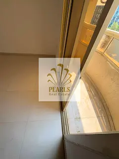 1BR apartment for annual rent in Ajman, with balcony behind Safeer Mall. AED 23,000 yearly, 4 paymen