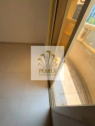 1BR apartment for annual rent in Ajman, with balcony behind Safeer Mall. AED 23,000 yearly, 4 payme