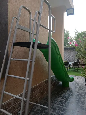 Outdoor kids slide with metal ladder - good condition