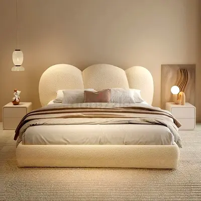 Beige upholstered queen bed with curved cloud headboard