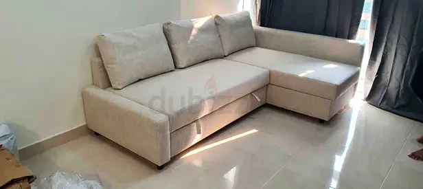 Light beige L-shaped sectional sofa - bed good condition