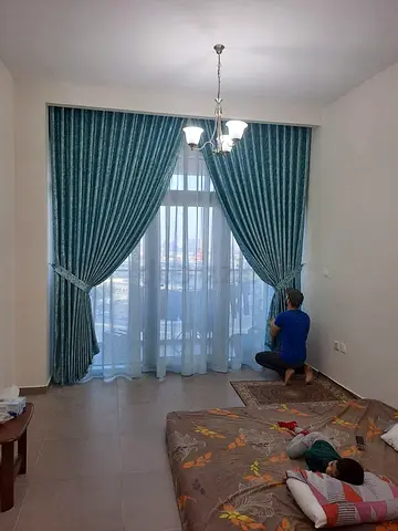 Teal floor-length blackout curtains with sheer lining - set for large window