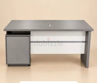 Modern grey office desk with storage cabinet and cable grommet