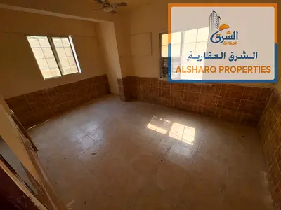Two-story Arabic-style house in Liwara 2, Ajman, featuring 7 rooms, 8 bathrooms, and 5 kitchens; suitable for companies. Price: 95,000.