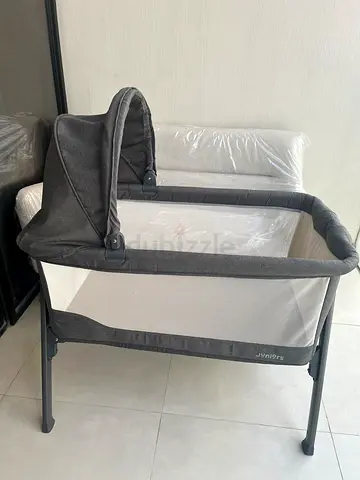 Light grey baby bassinet / bedside crib in good condition with Mattress and Mattress protector