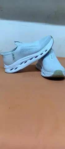 Lightweight white slip-on athletic sneakers - size not specified