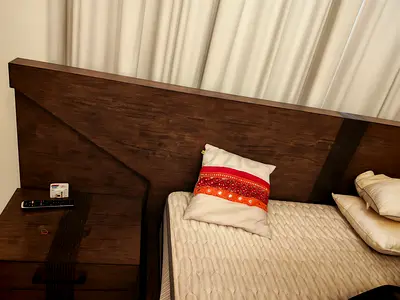 Dark wood queen bed frame with matching bedside table