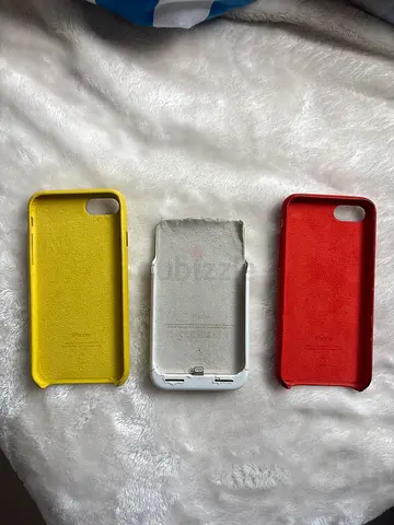Three used iPhone silicone/leather cases (red, white (power bank), yellow) - various wear