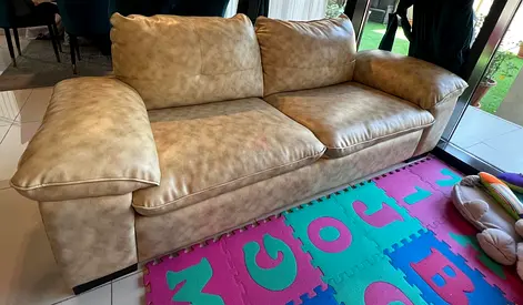3-seater beige faux leather sofa — good condition